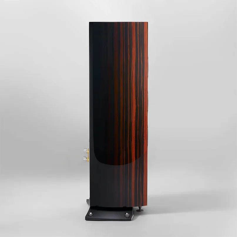 Triangle Magellan Cello 40Th Hi-Fi Floorstanding Speaker Tall floor-standing loudspeaker with black wood veneer and orange vertical stripes, side gold binding posts, mounted on a metal base.