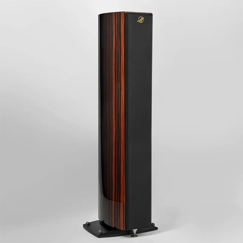 Triangle Magellan Quatuor 40Th Hi-Fi Floorstanding Speaker Tall black floorstanding speaker with vertical wood veneer panels, gold emblem at top, on a curved base with metal feet.