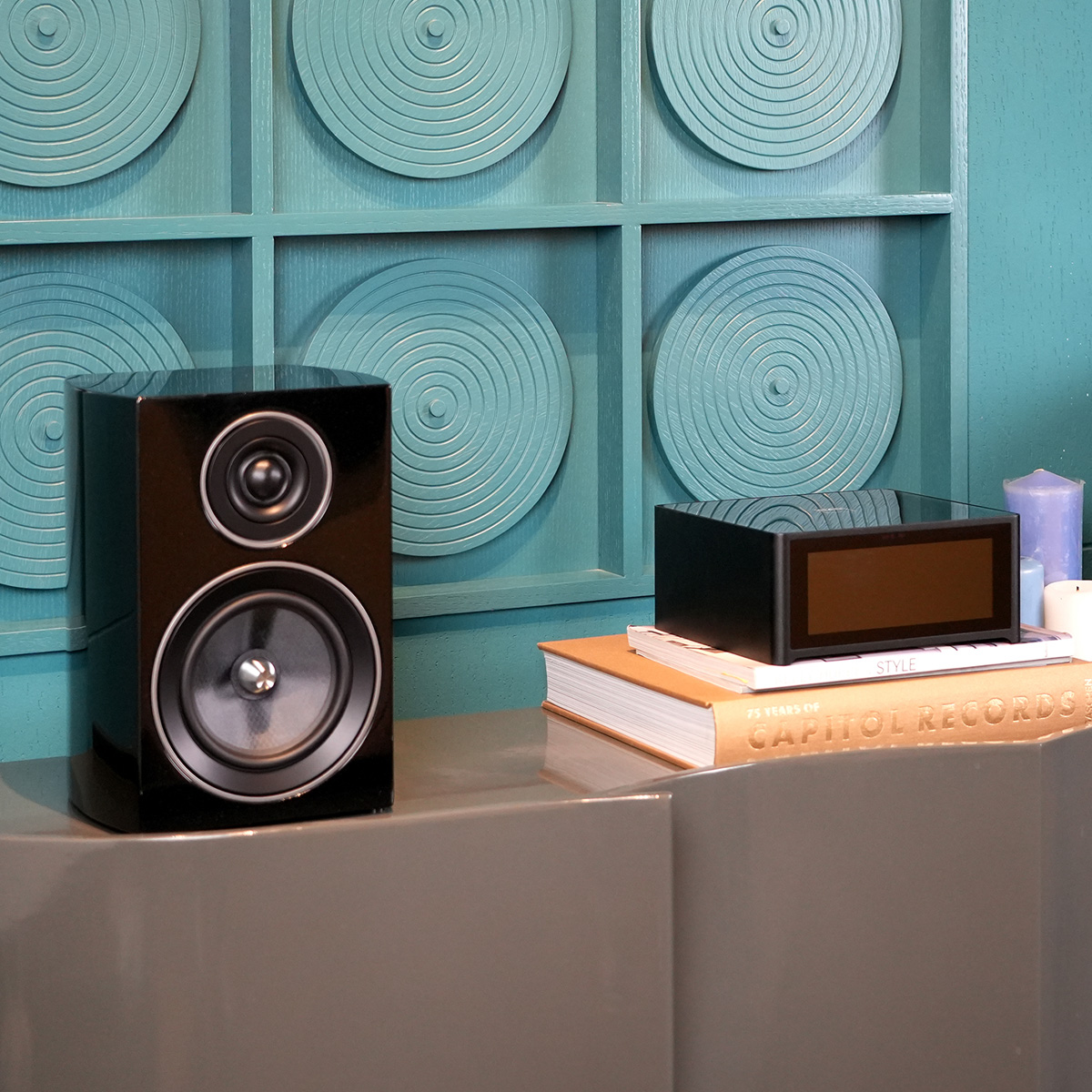 Jamo C707 Pa Active Bookshelf Speaker Black bookshelf speaker with two drivers beside compact digital audio player.
