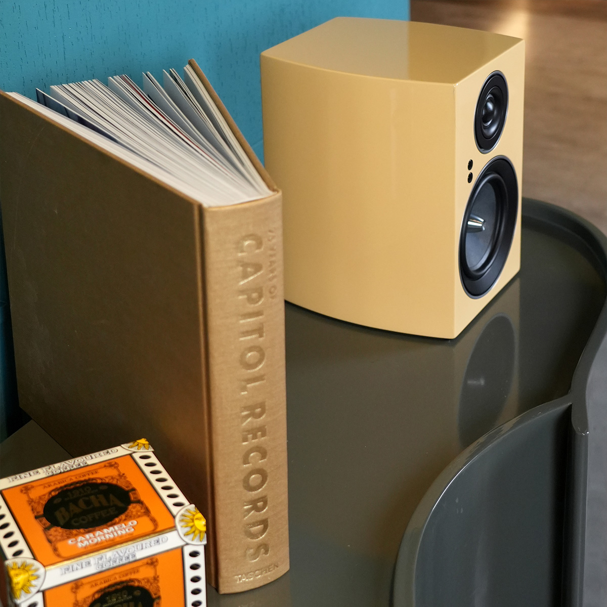 Jamo C707 Pa Active Bookshelf Speaker Beige two-driver speaker beside capitol records book.