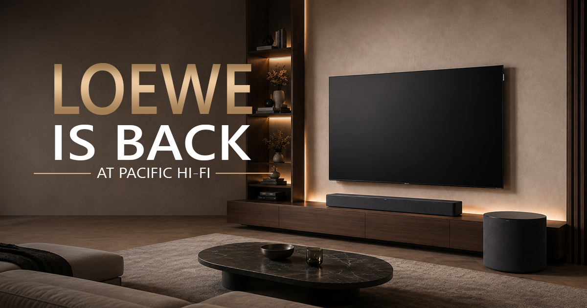 Loewe Returns To Pacific Hi-Fi Modern living room with a large loewe oled tv on the wall, accompanied by a loewe klang bar5 & sub5 beneath it, and the text “loewe is back at pacific hi-fi” displayed prominently on the left side.
