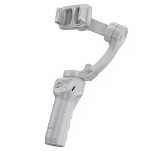 The HOCO. Smart Gimbal “K24 Support” Anti-Shake 3-Axis is a gray handheld smartphone stabilizer featuring control buttons and an adjustable arm for mounting your phone, displayed against a white background.