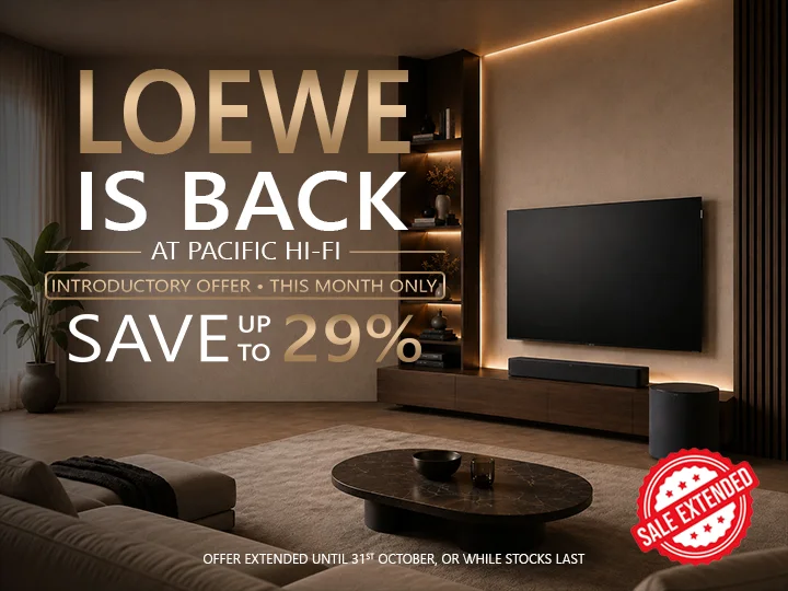 Loewe flat-screen television mounted on a wall in a modern living room with ambient backlighting.