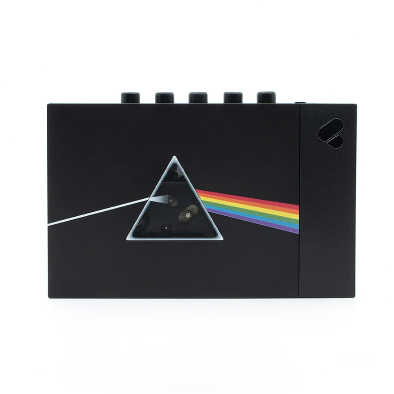 We Are Rewind Limited Edition Pink Floyd Portable Cassette Player &Amp; Recorder We are rewind limited edition pink floyd portable cassette player & recorder black rectangular electronic device with five top knobs and a triangular prism rainbow graphic on the front.