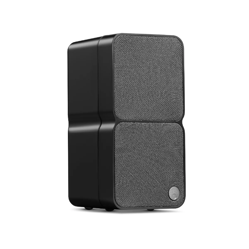 Black wireless speaker with two fabric-covered square front panels and a rounded enclosure.