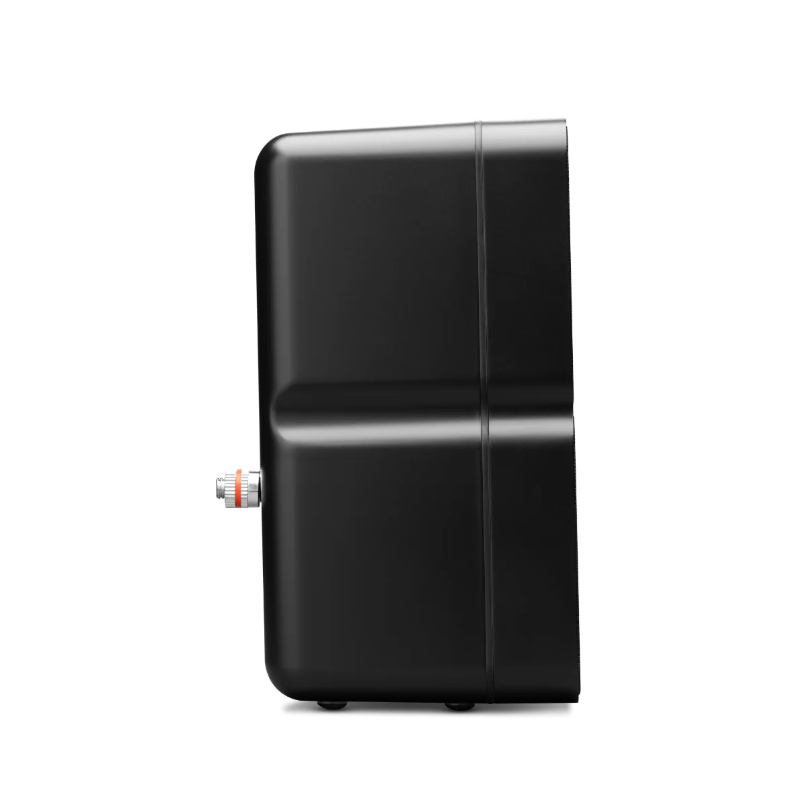 Black rectangular electronic device with rounded edges and a side orange-ringed knob, resting on small feet