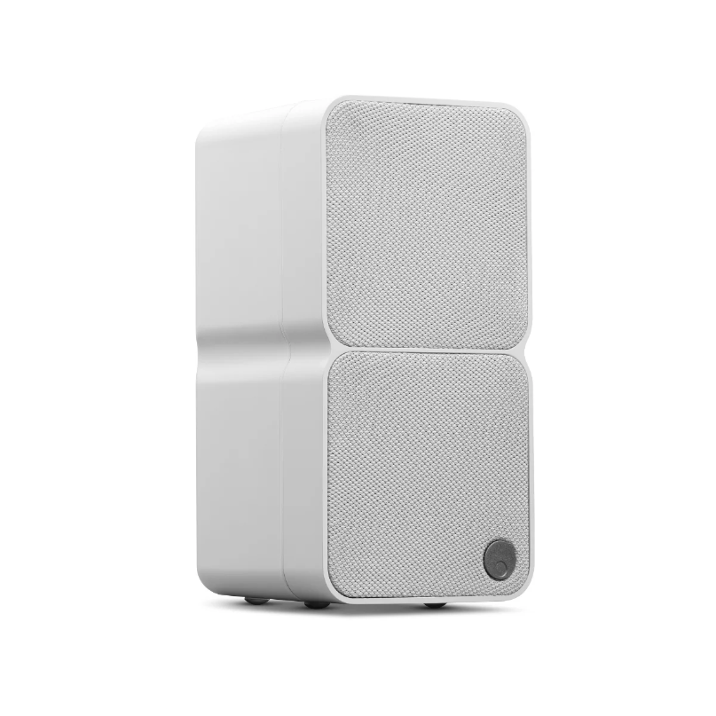 White dual-front speaker with two fabric grille panels, rounded edges, and a small circular control at the bottom.